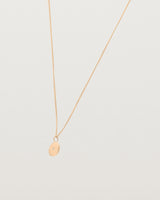 Angled view of the Eily Necklace with a diamond in rose gold.