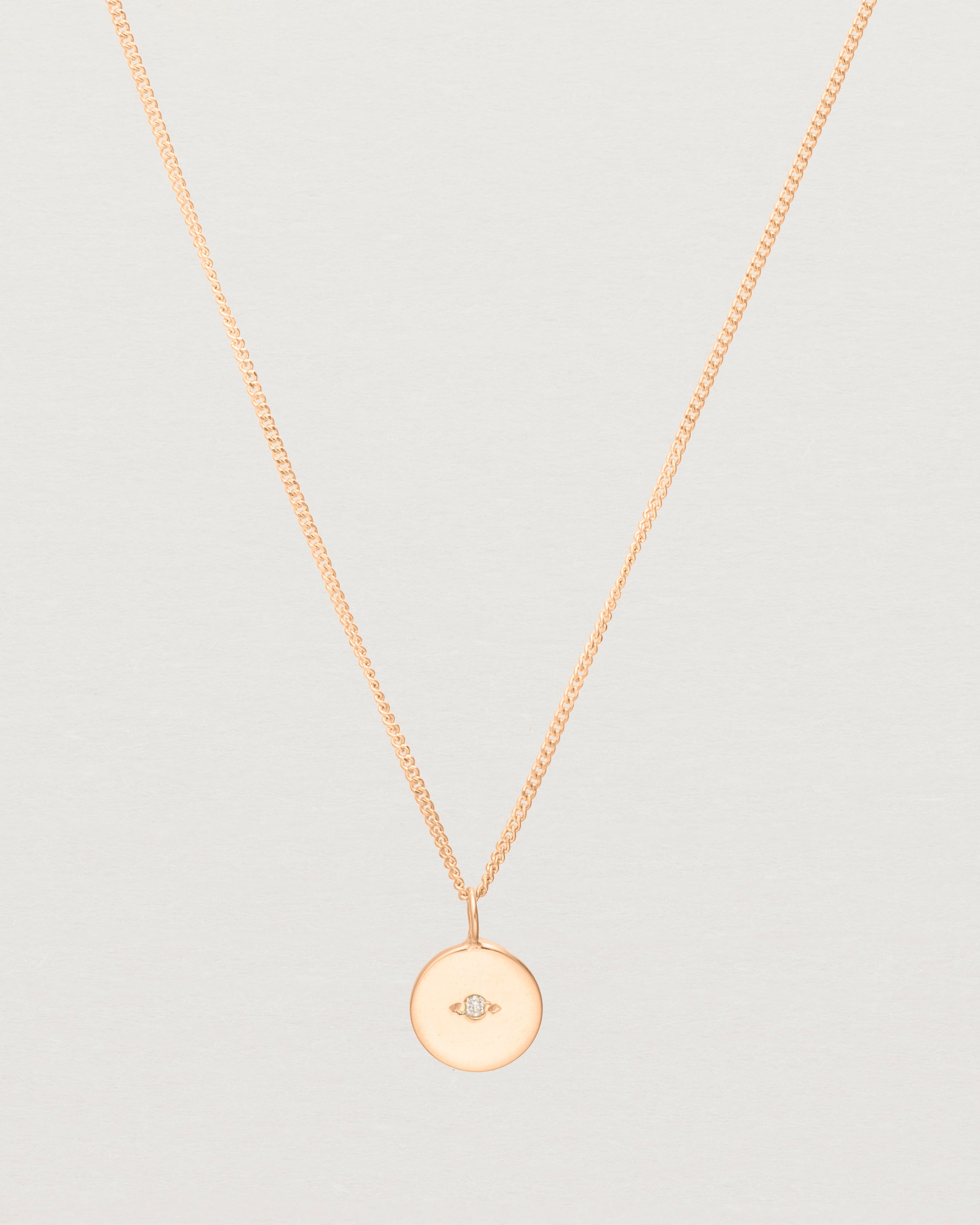 Close up of the Eily Necklace with a diamond in rose gold.