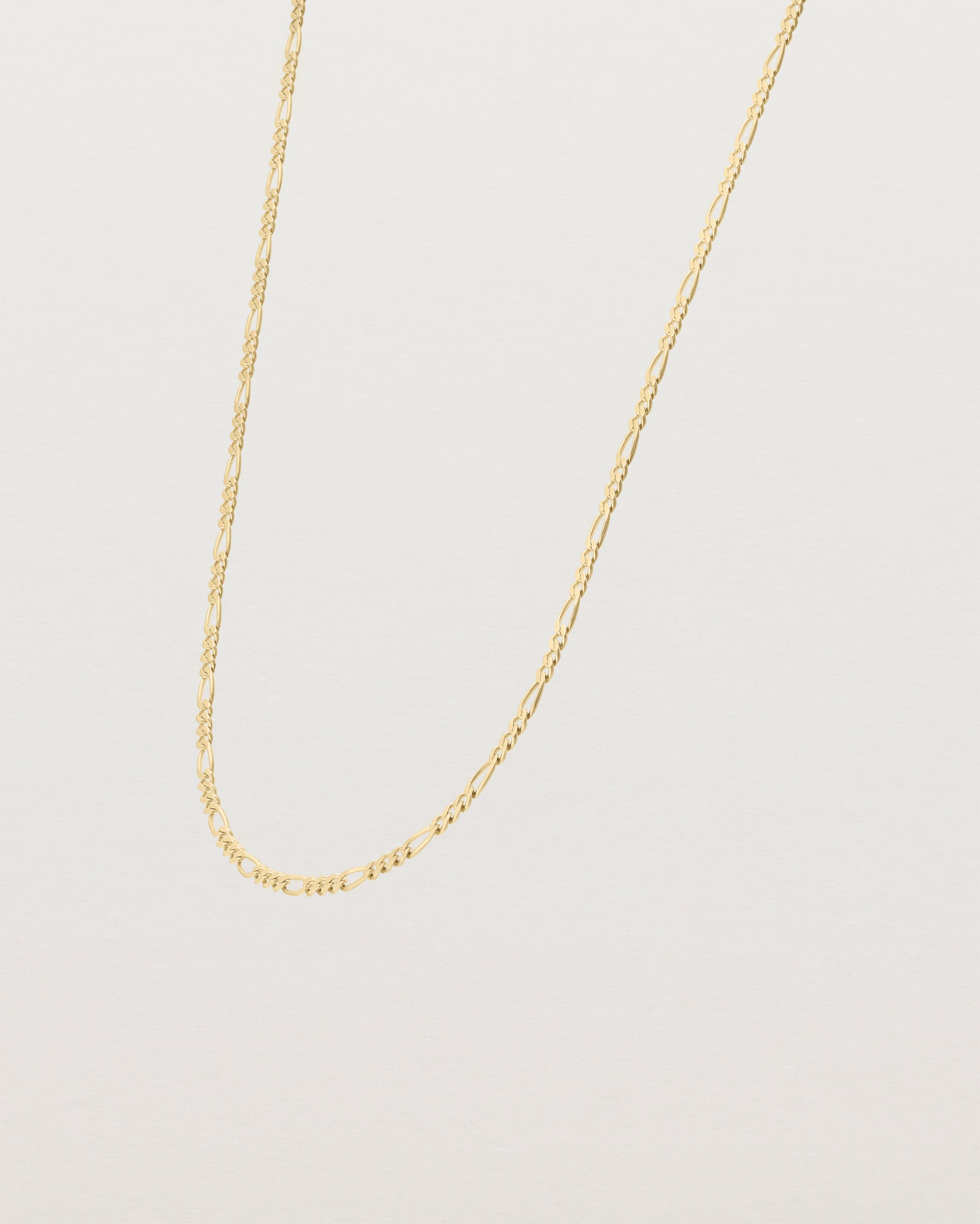 Angled view of the the Figaro Chain Necklace | Bold in Yellow Gold.