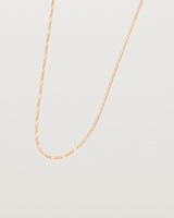 Angled view of Close up of the Figaro Chain Necklace | Bold in Rose Gold.