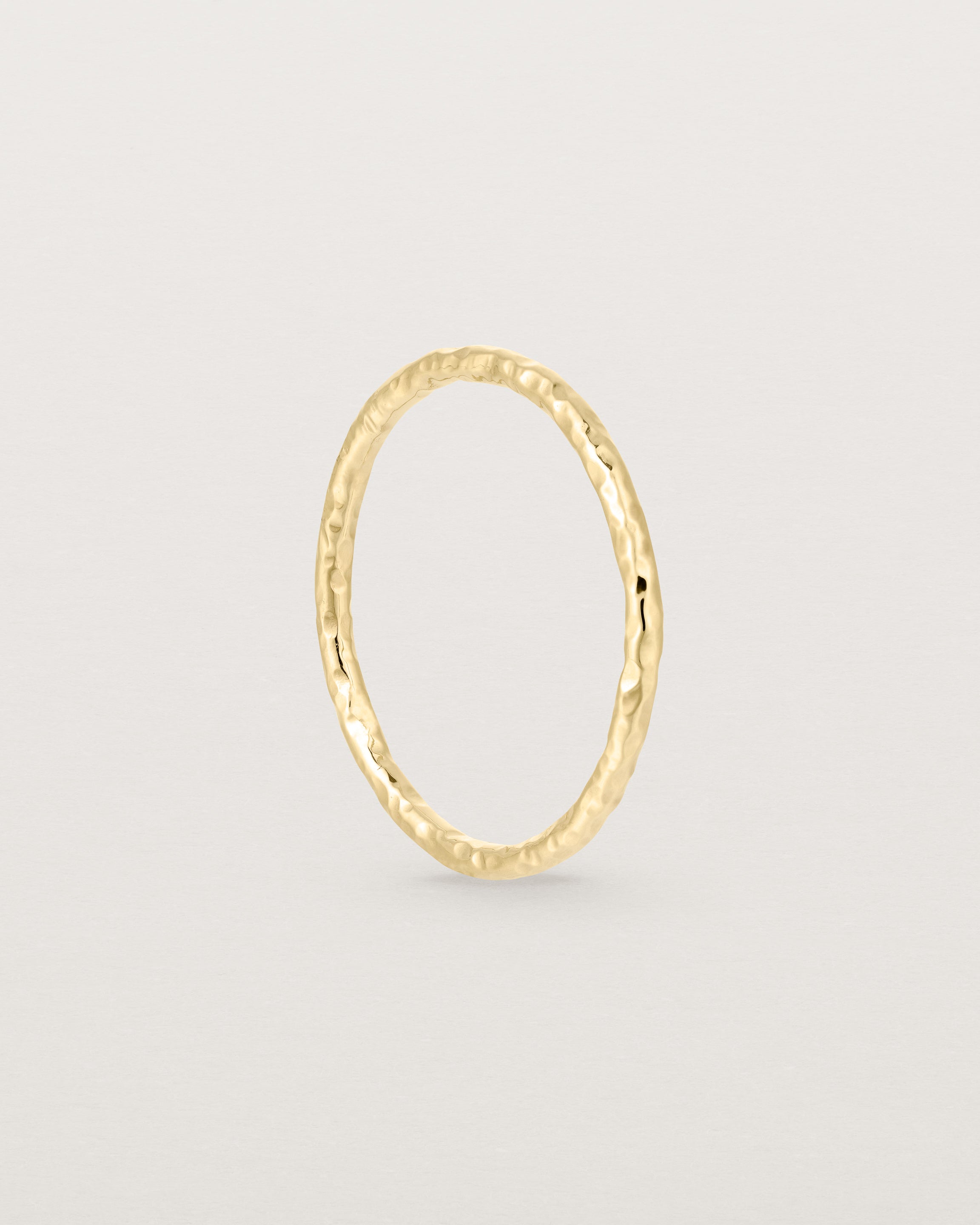 Standing view of the Faceted Wedding Ring in Yellow Gold.