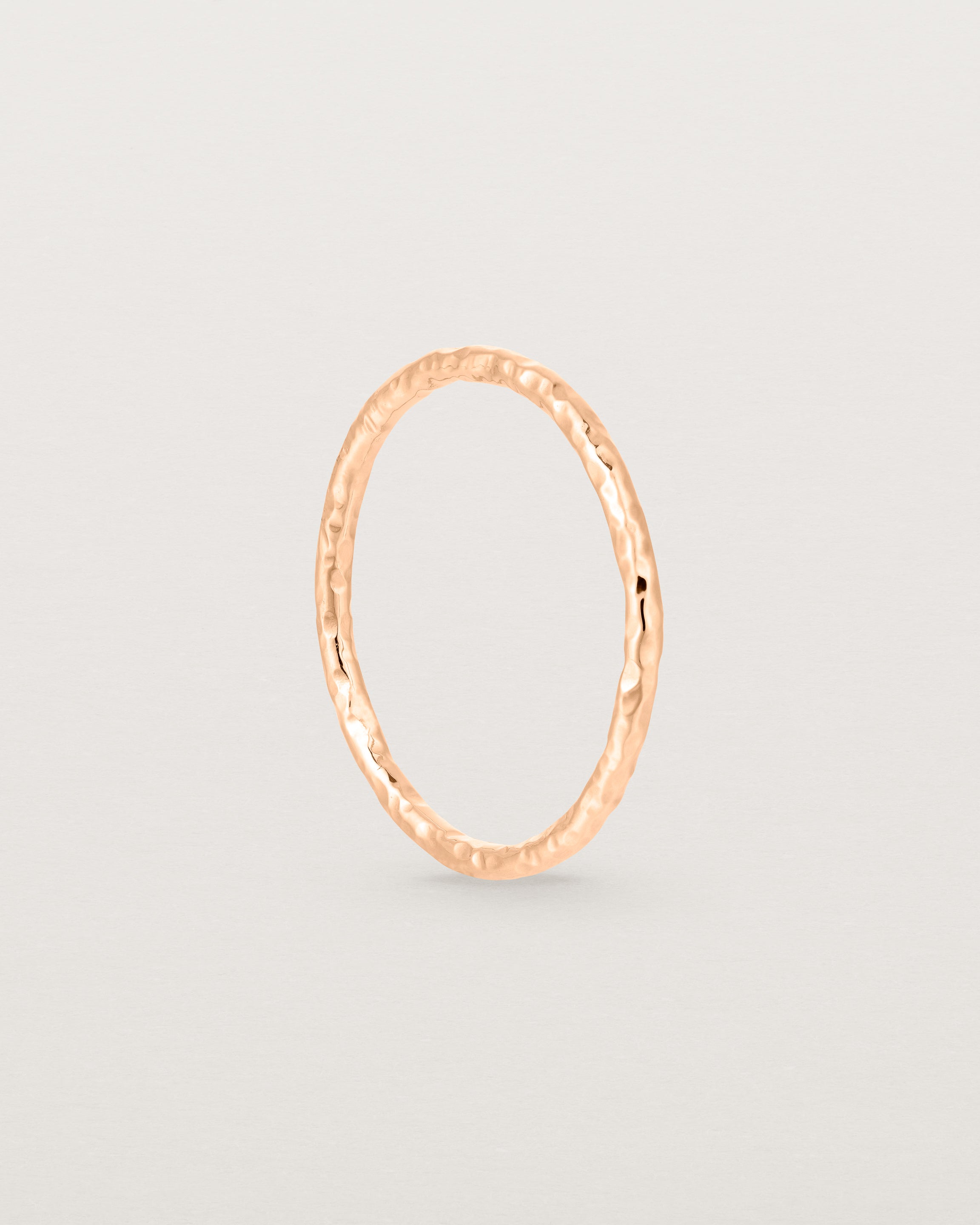 Standing view of the Faceted Wedding Ring in Rose Gold.