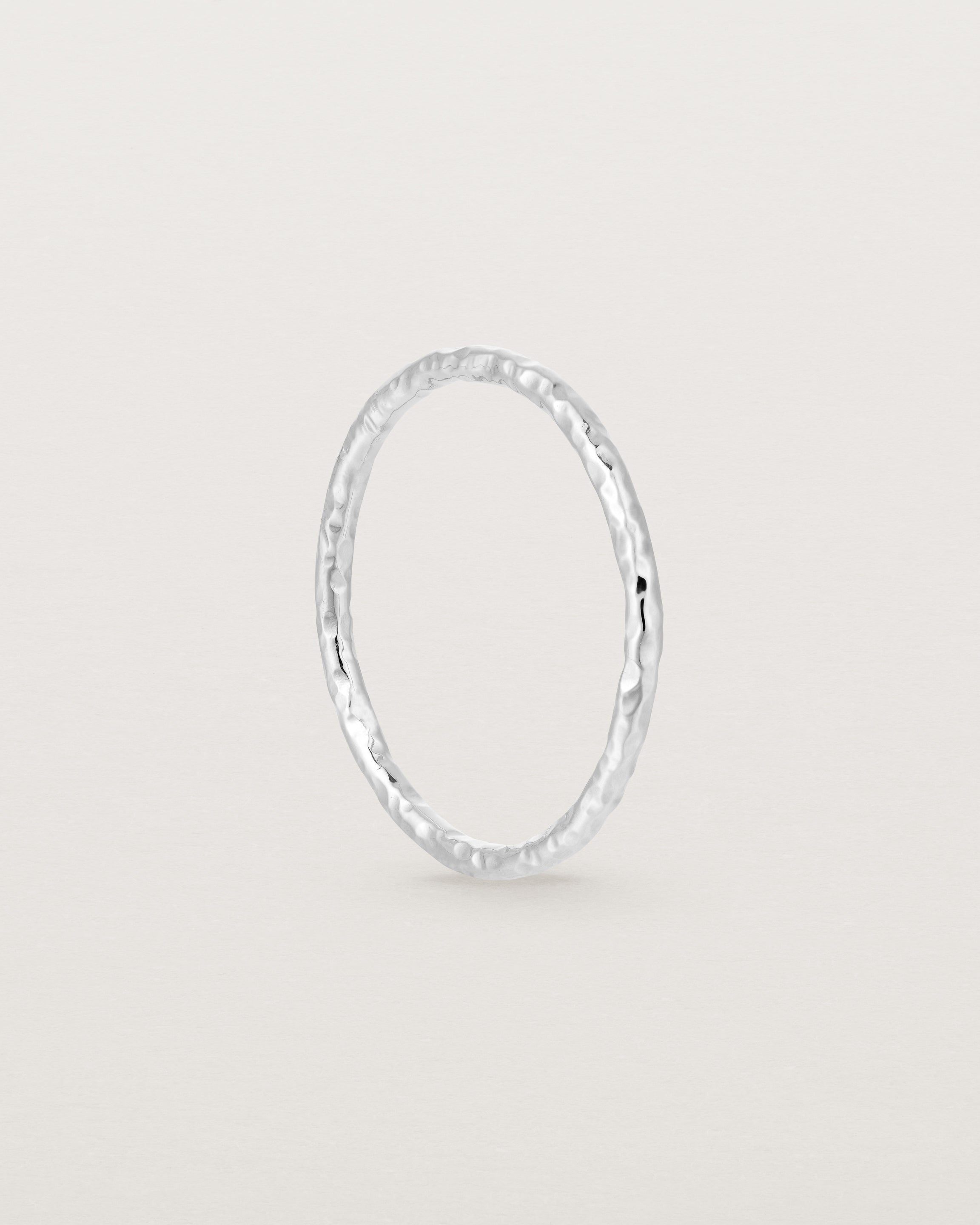Standing view of the Faceted Wedding Ring in White Gold.