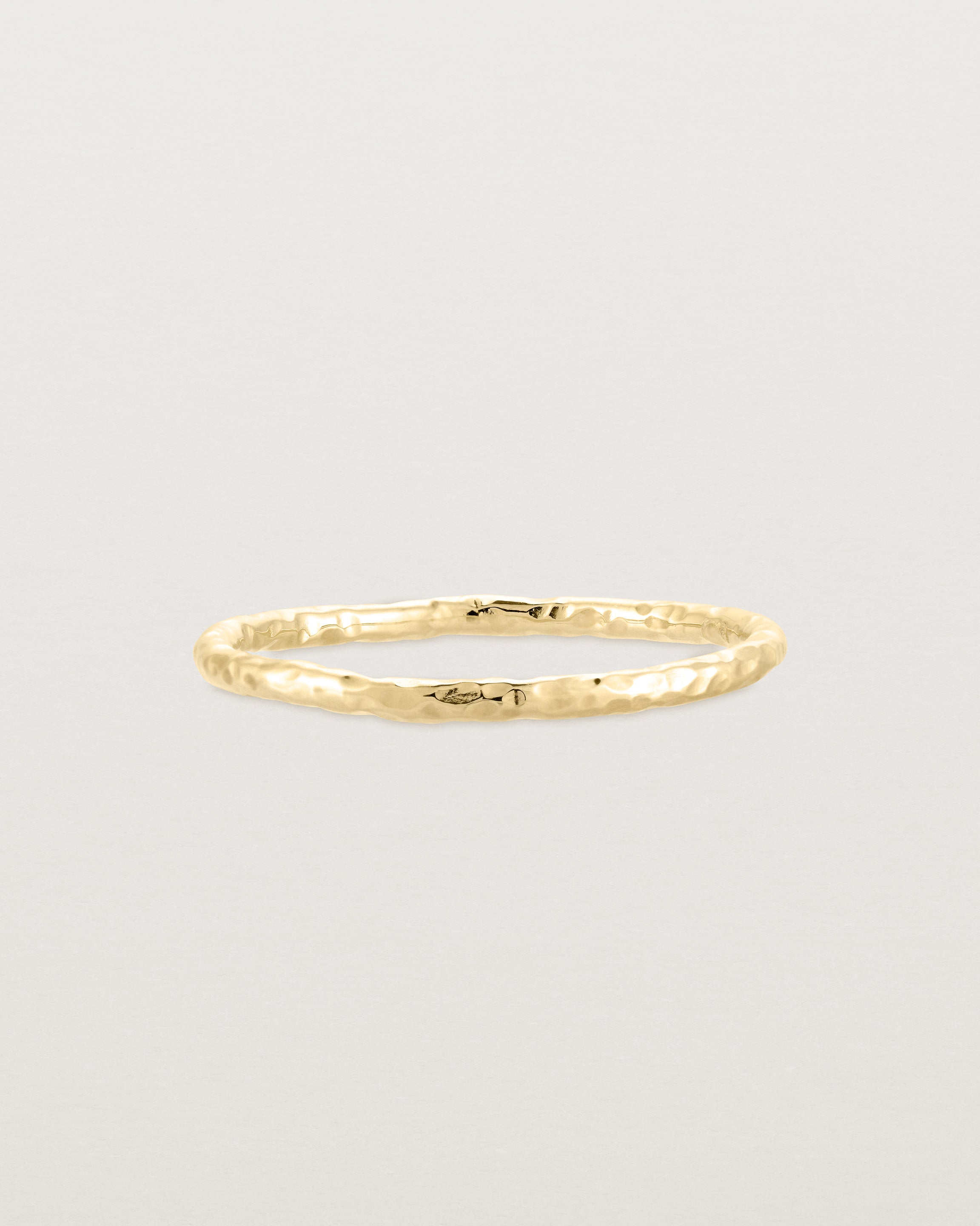 Front view of the Faceted Wedding Ring in Yellow Gold.