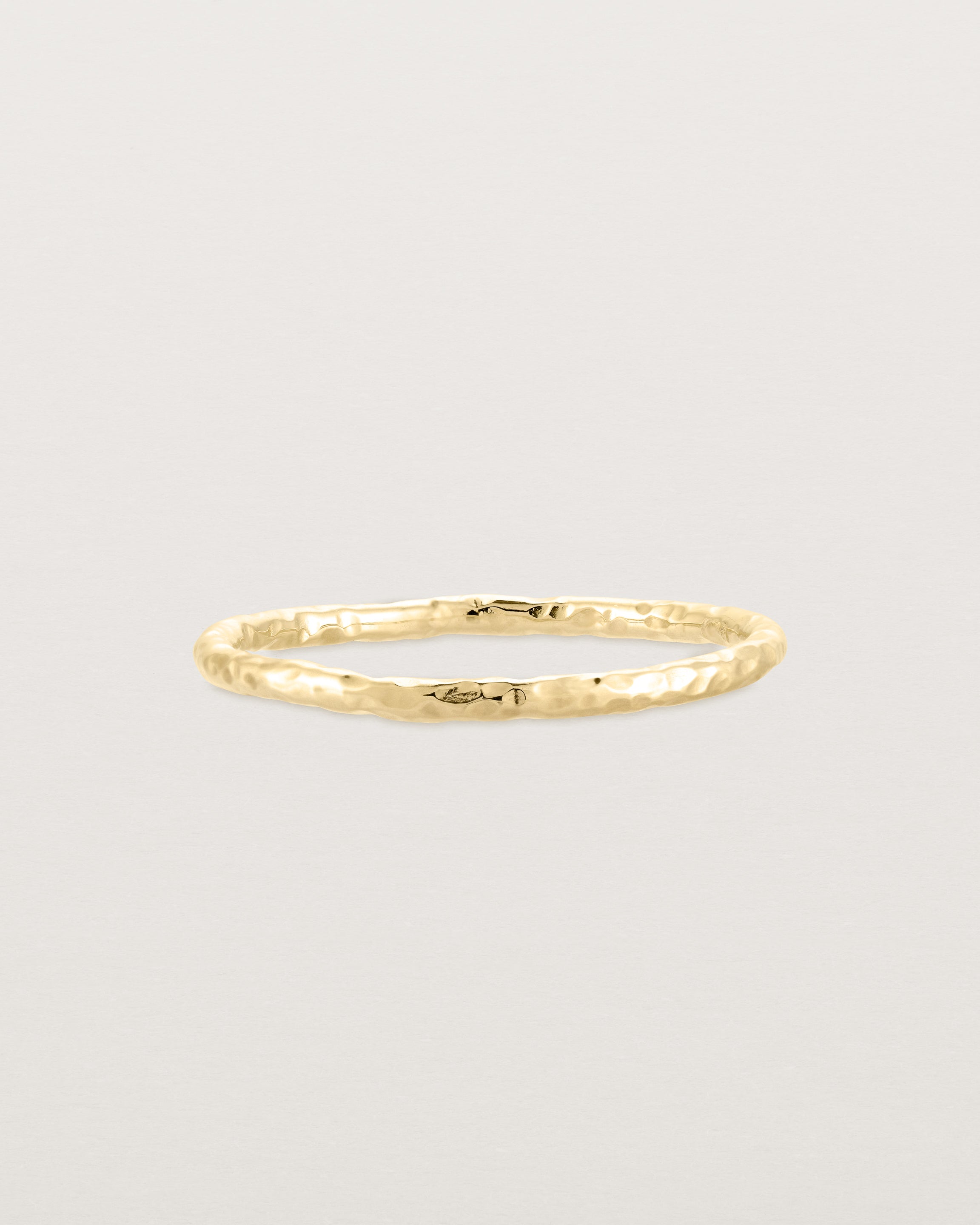 Front view of the Faceted Wedding Ring in Yellow Gold.