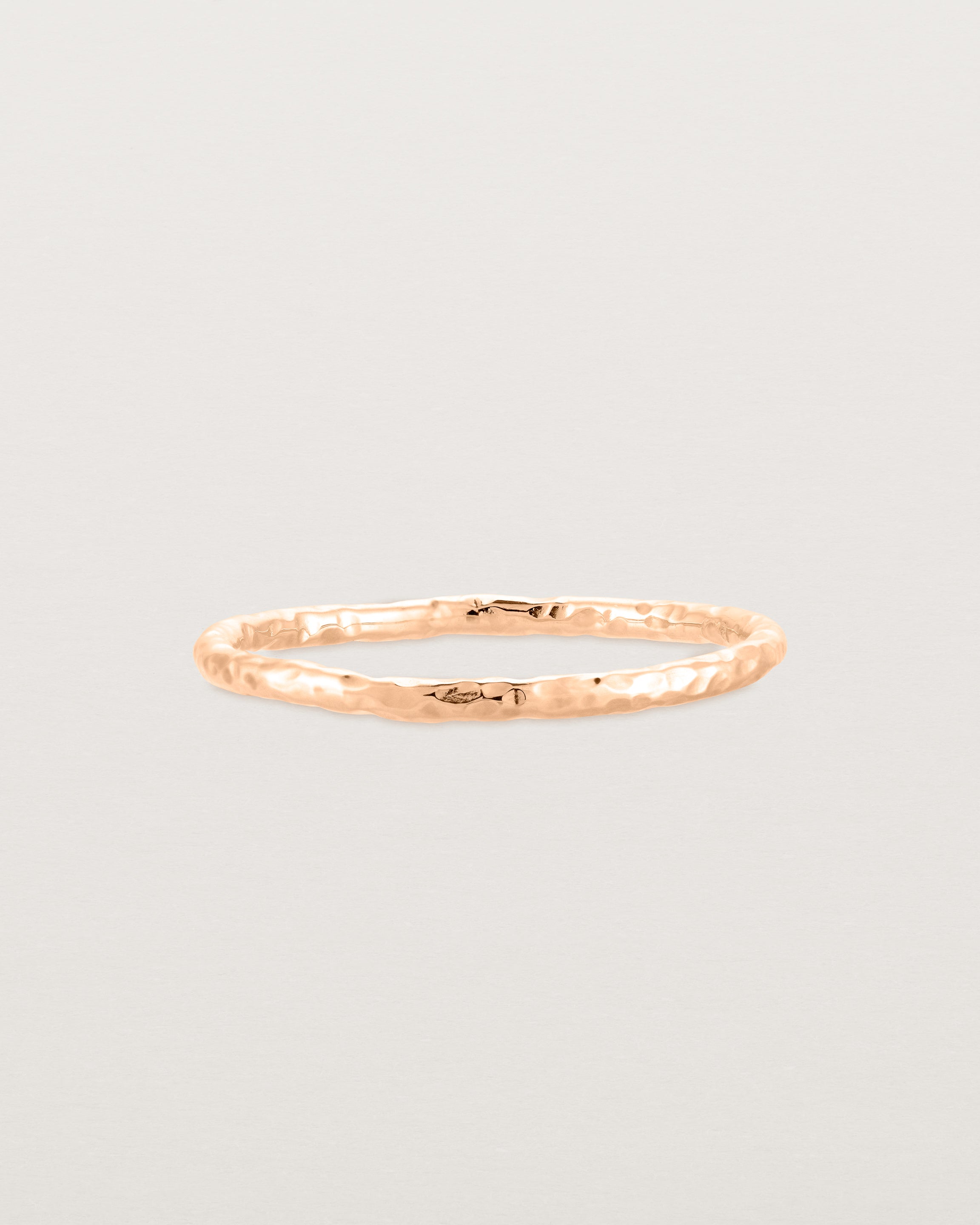 Front view of the Faceted Wedding Ring in Rose Gold.