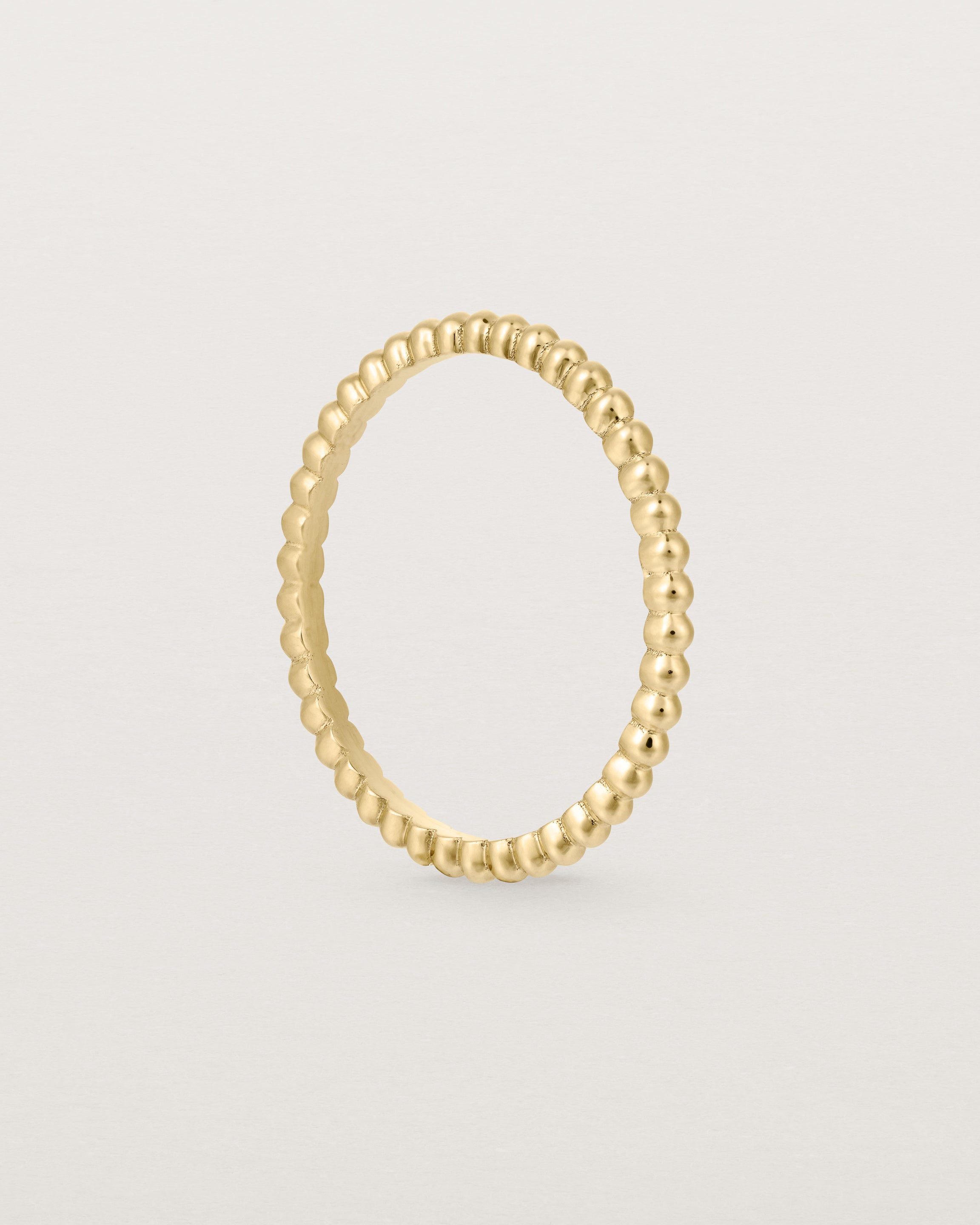 Standing view of the Dotted Stacking Ring in Yellow Gold.