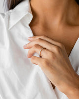 A woman wearing the Grace Ring | White Diamonds in Yellow Gold.