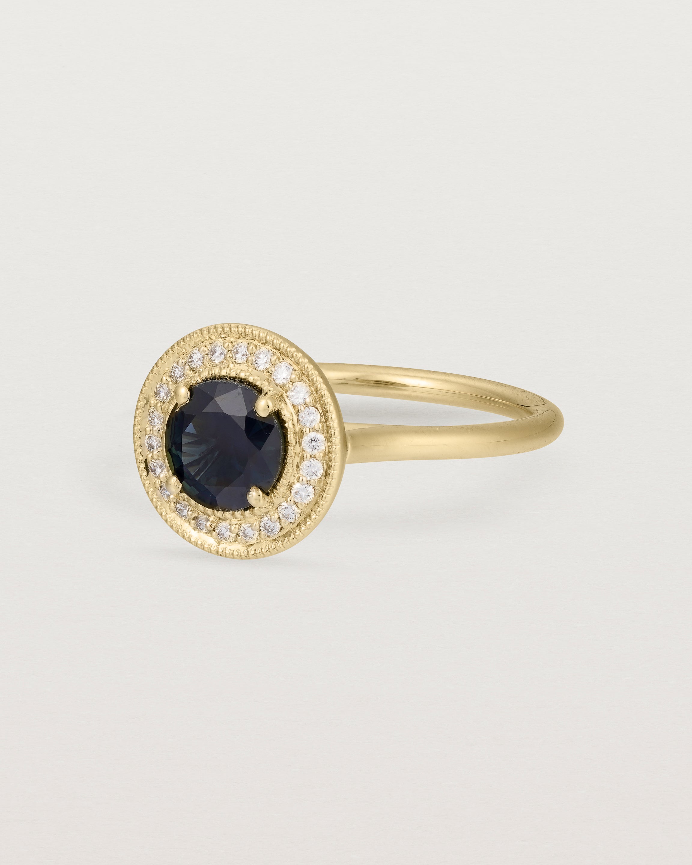 Angled view of Imogen Halo Ring | Australian Sapphire & Diamonds in Yellow Gold.