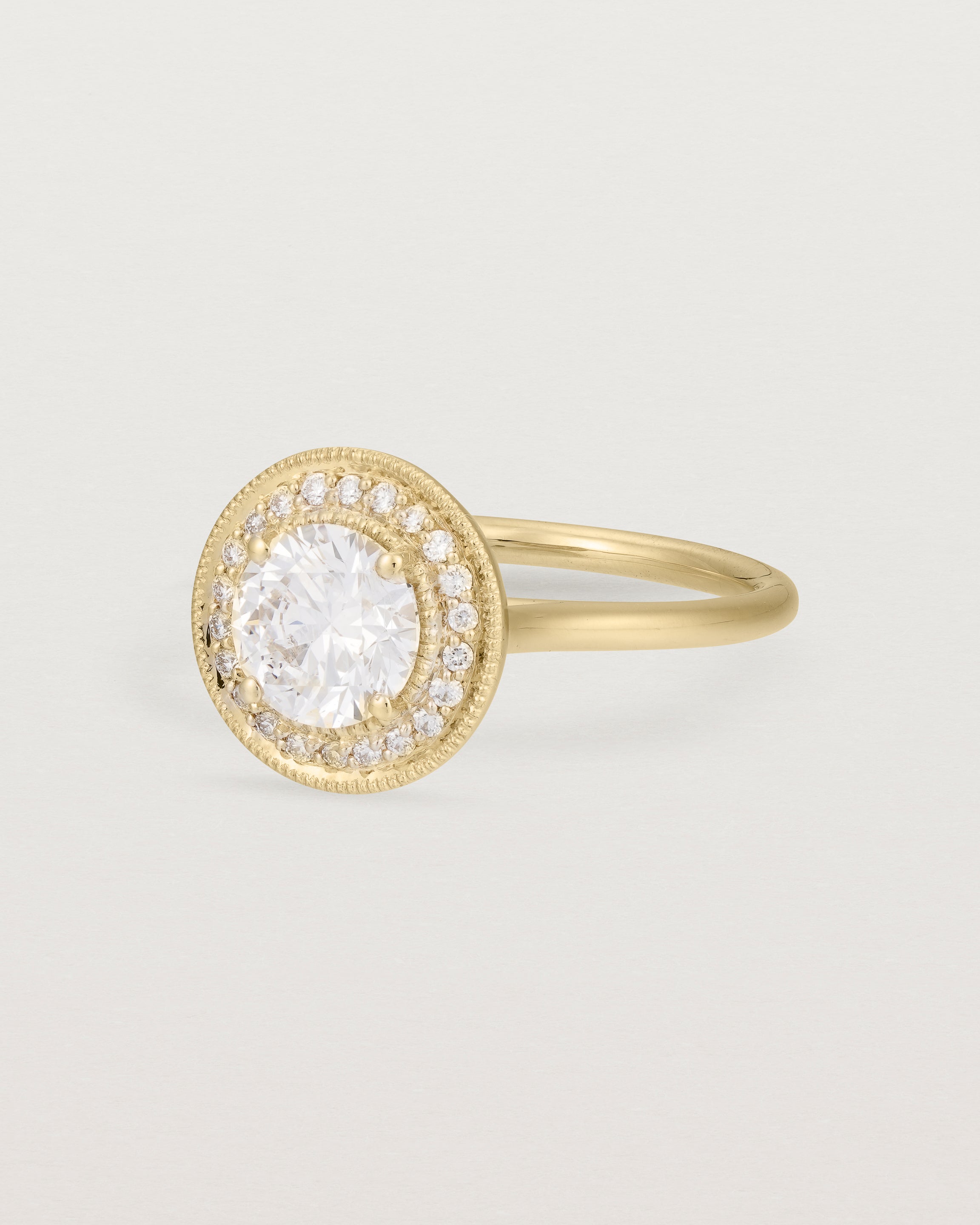 Angled view of the Imogen Halo Ring | Laboratory Grown Diamonds in Yellow Gold.
