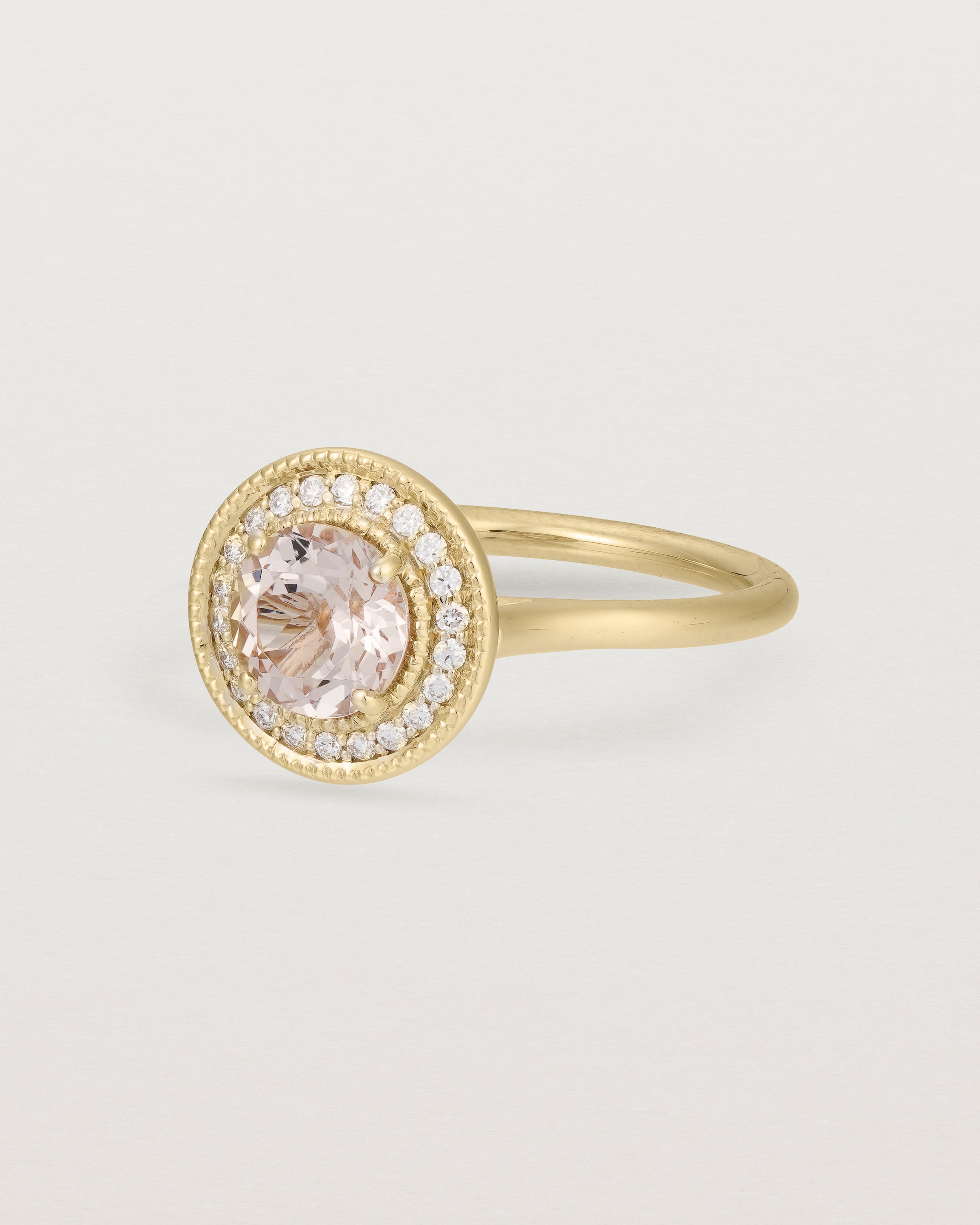 Angled view of the Imogen Halo Ring | Morganite & Diamonds in Yellow Gold.