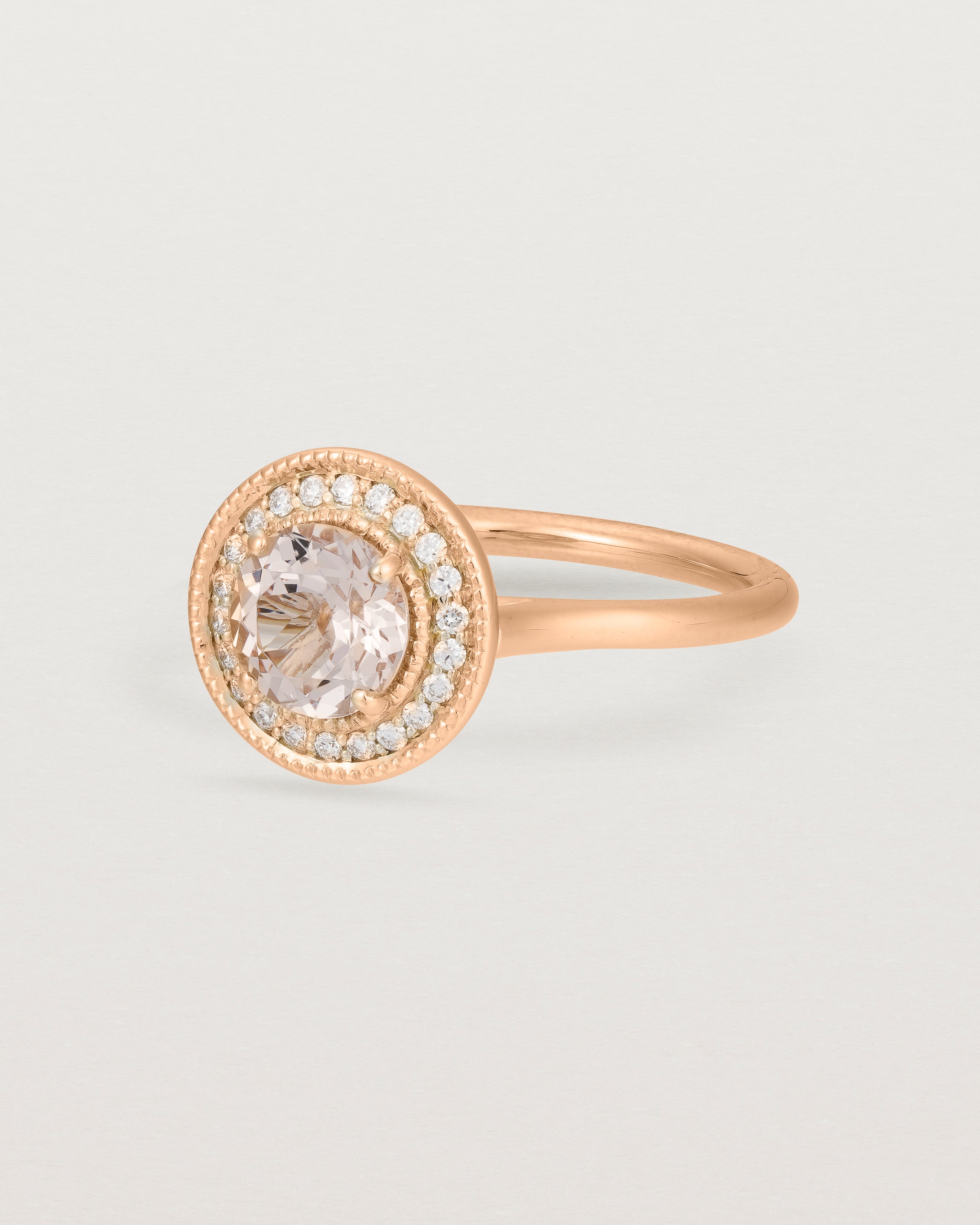 Angled view of the Imogen Halo Ring | Morganite & Diamonds in Rose Gold.
