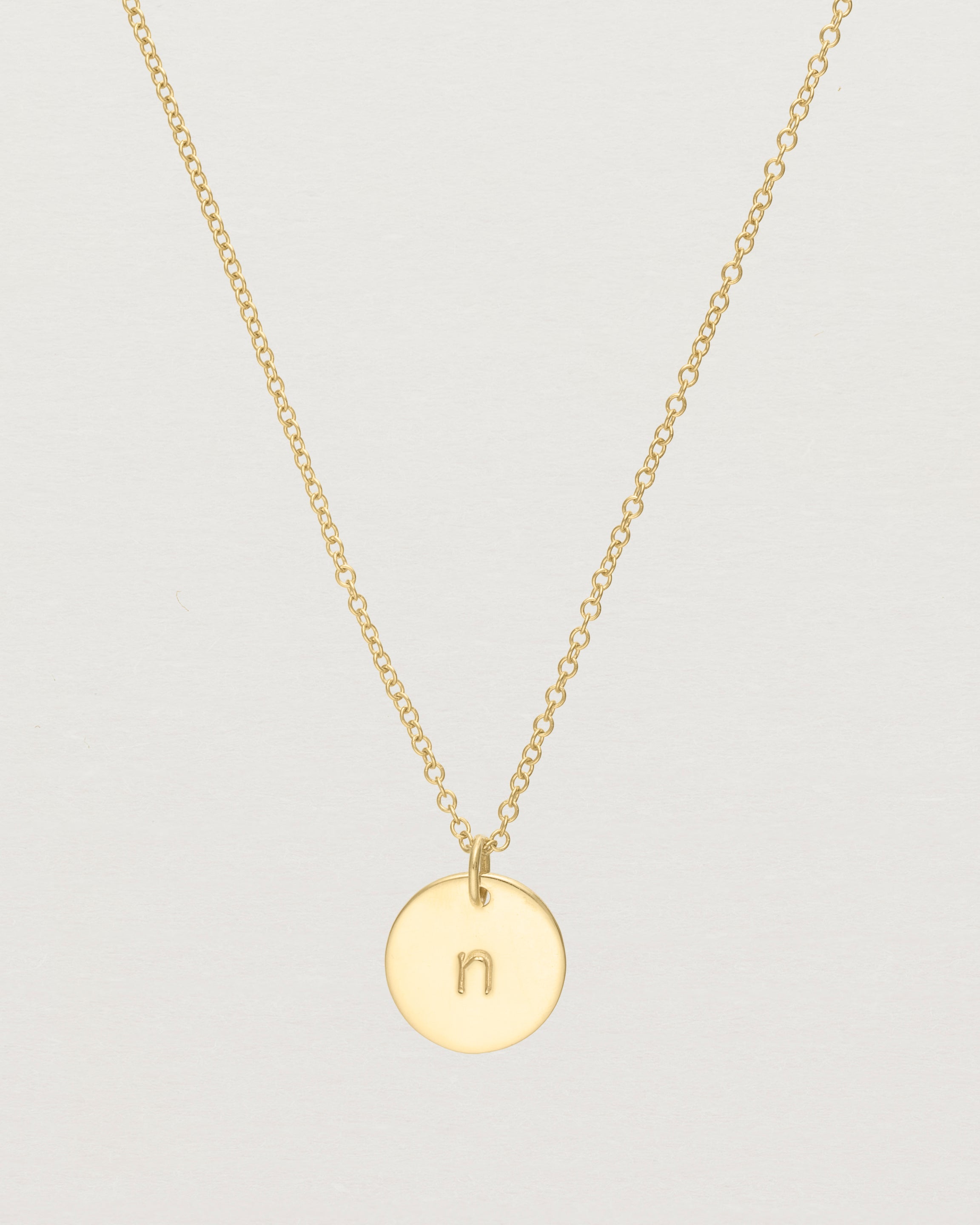 Close up of the Mini Initial Necklace in Yellow Gold.