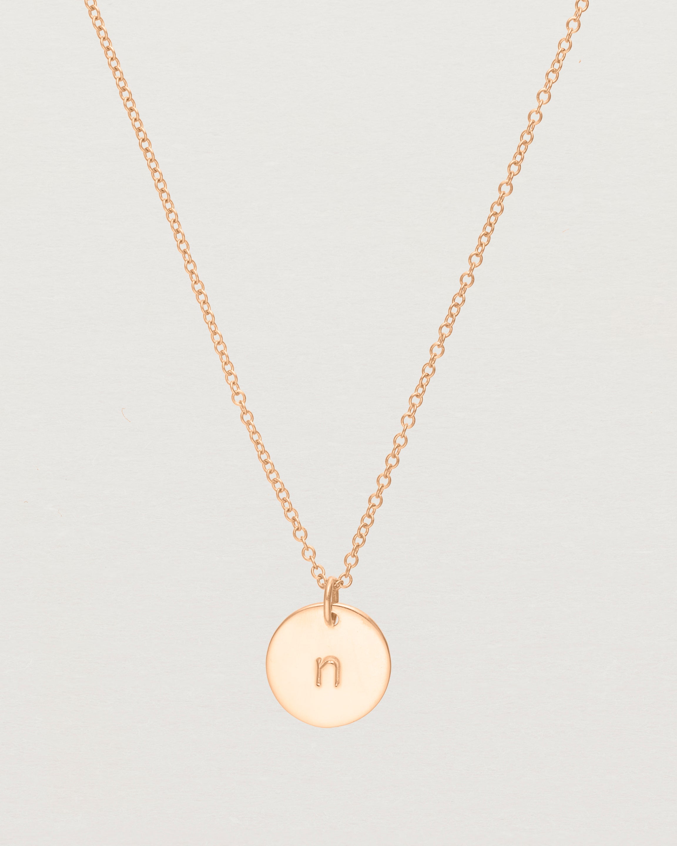 Close up of the Mini Initial Necklace in Rose Gold.