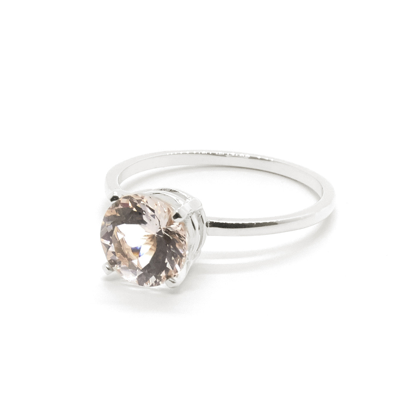 The Precious Morganite Engagement Ring in Rose Gold with a round cut light pink morganite shown from a slight angle.