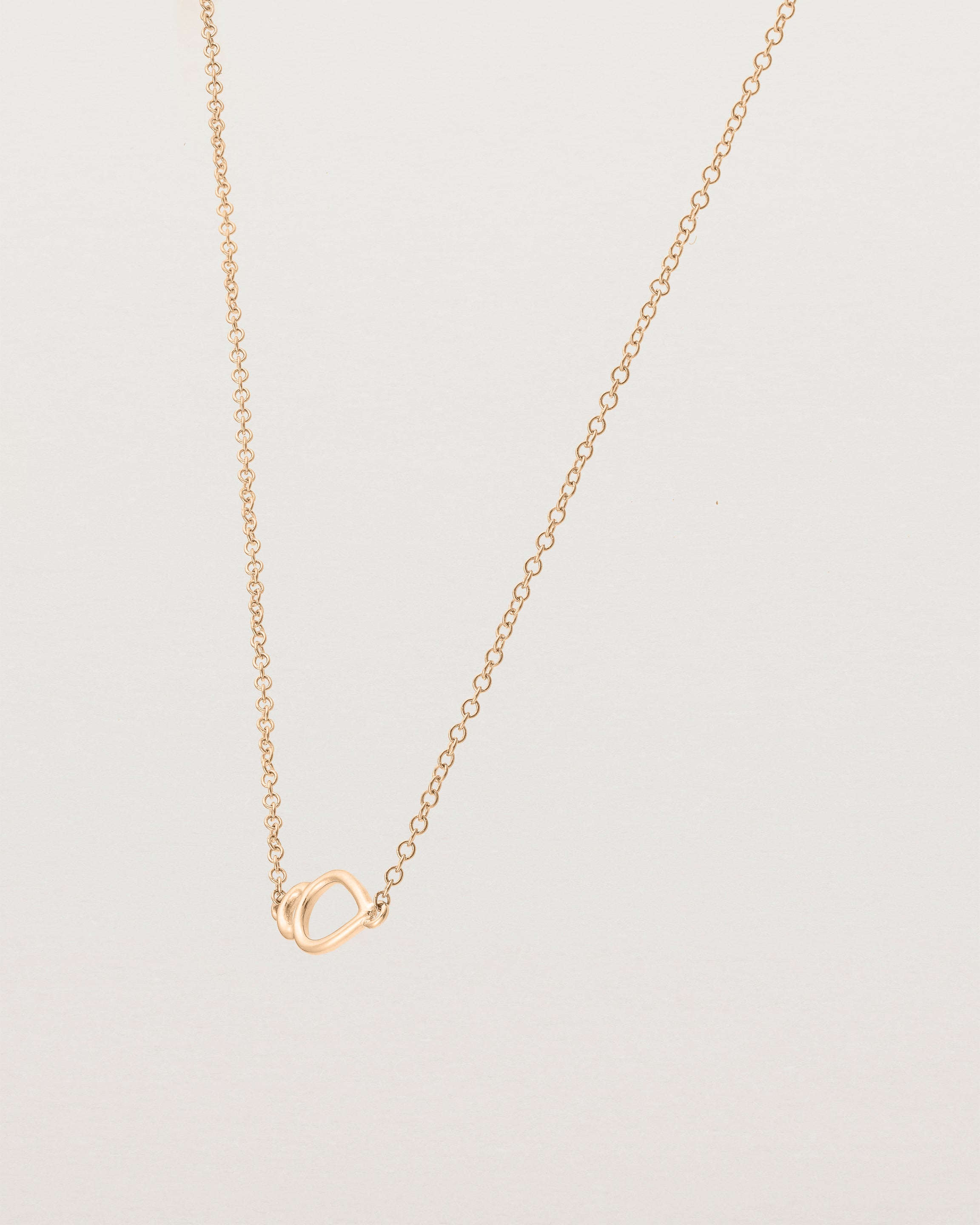 Angled view of  the Oana Necklace in Rose Gold.