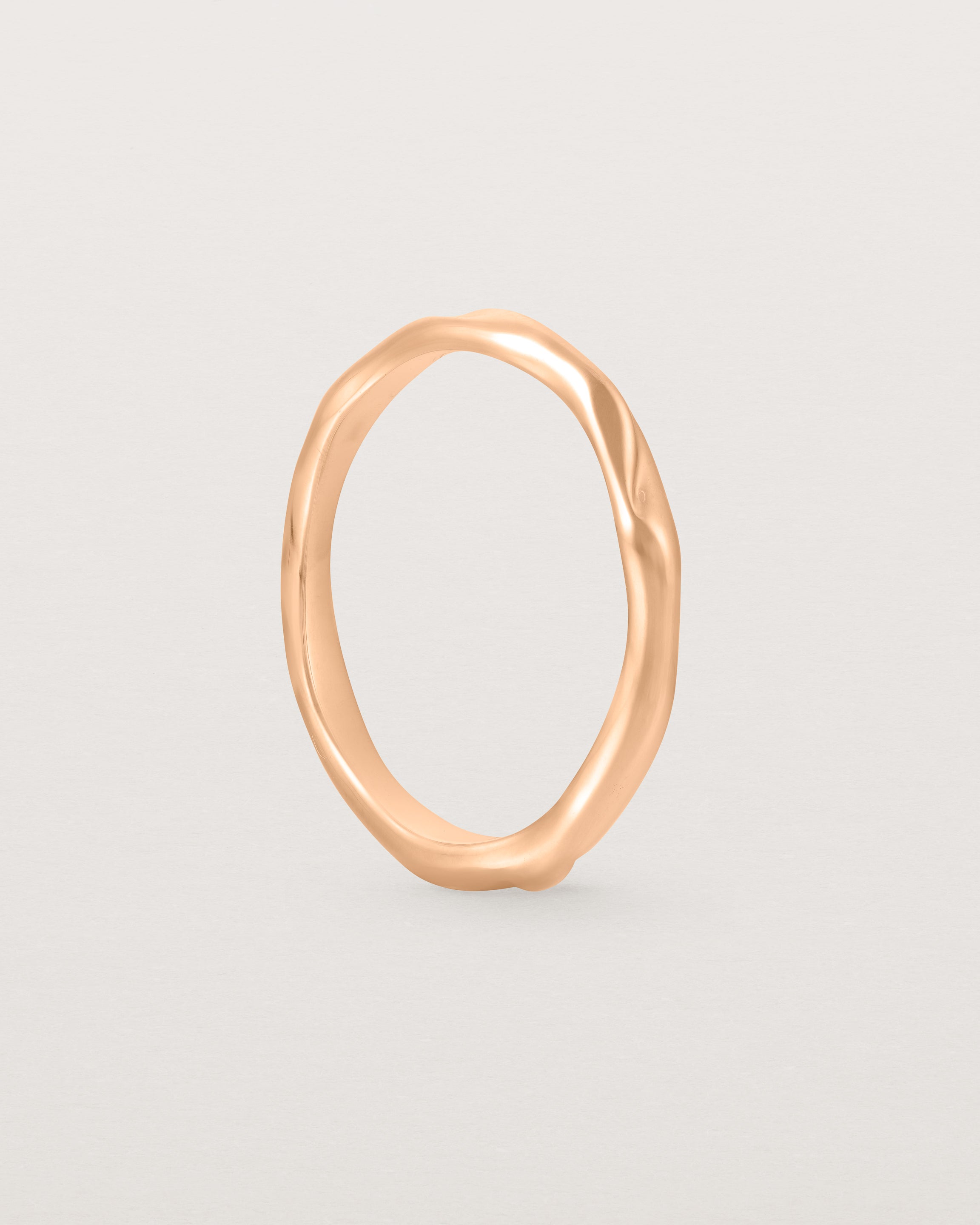 The Organic Wedding Ring | 2mm in Rose Gold standing.