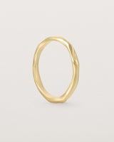 The Organic Wedding Ring | 2mm in Yellow Gold standing.
