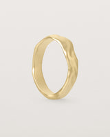 The Organic Wedding Ring | 4mm | Yellow Gold standing. 