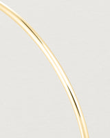 Close up of the detail of the Oval Bangle in Yellow Gold.