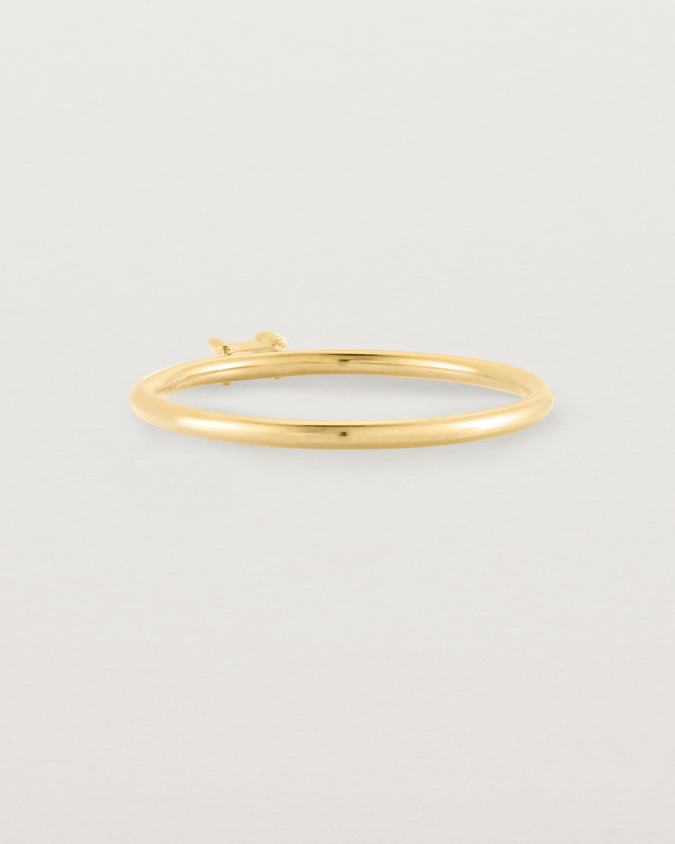 fine yellow gold ring featuring a emerald cut pale blue sapphire