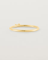 fine yellow gold ring featuring a emerald cut pale blue sapphire