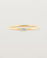 fine yellow gold ring featuring a emerald cut pale blue sapphire