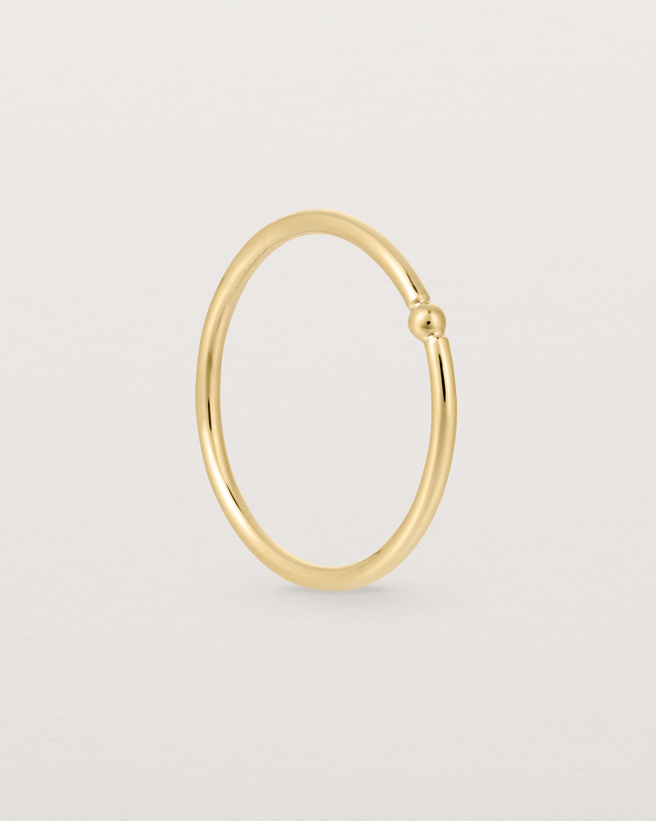 Standing view of the Suspend Ring in Yellow Gold.