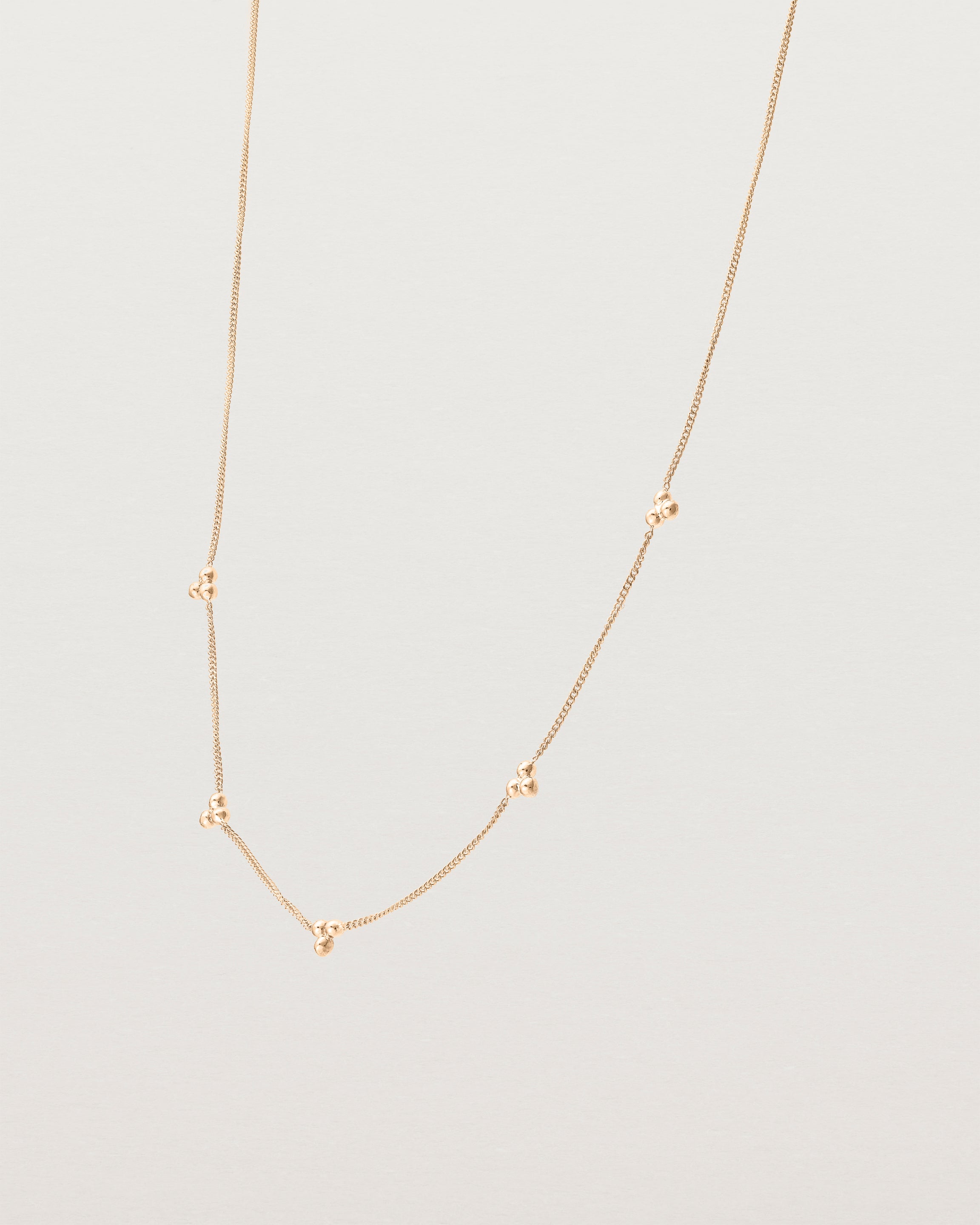 Angled view of the Tellue Necklace in rose gold.