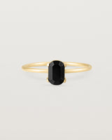 Fine yellow gold band featuring an oval black spinel stone