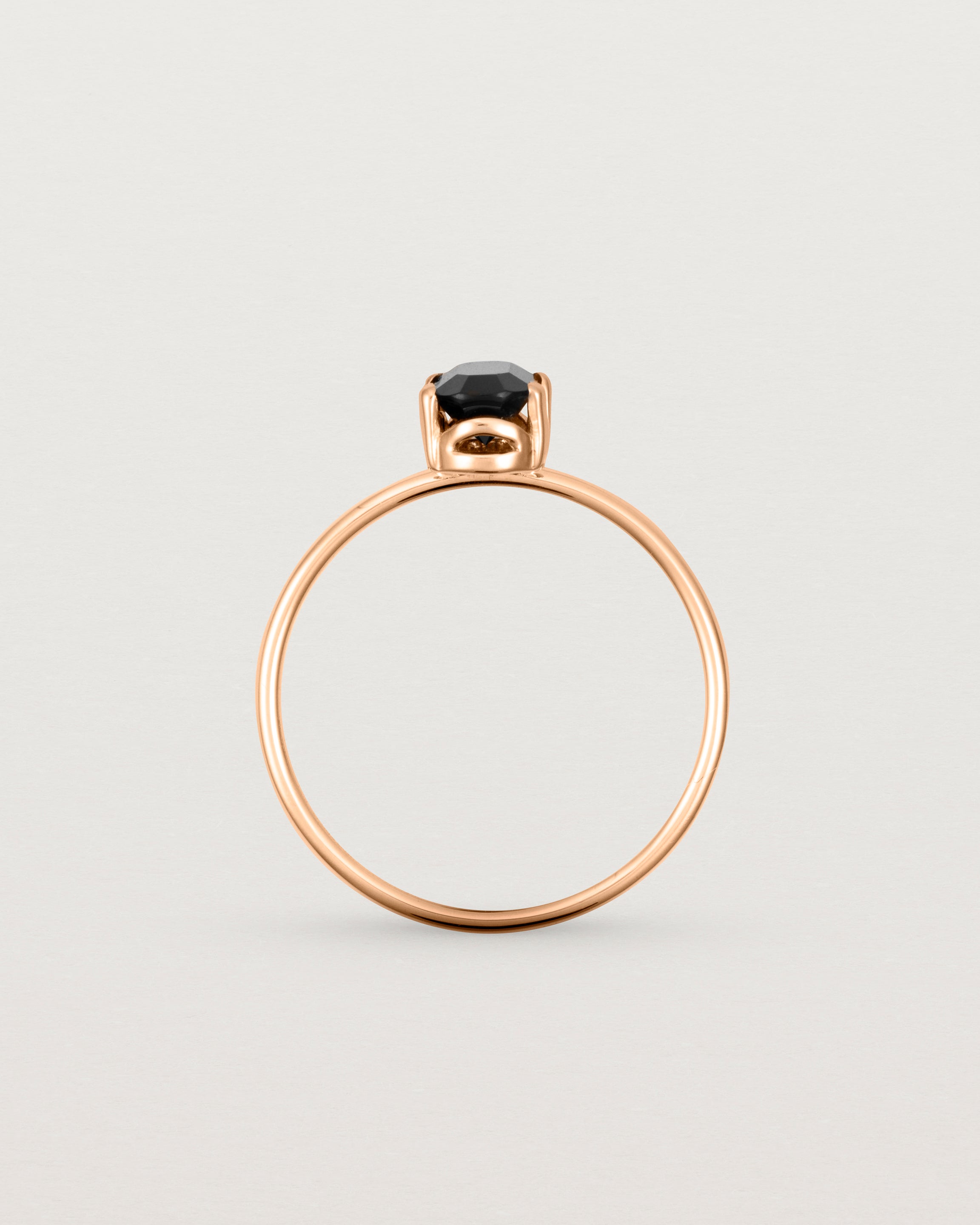 Fine rose gold band featuring an oval black spinel stone