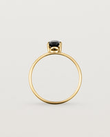 Fine yellow gold band featuring an oval black spinel stone