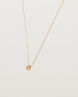 Angled view of the Tiny Marquise Necklace with Rutilated Quartz in rose gold.