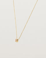 Angled view of the Tiny Marquise Necklace with Rutilated Quartz in yellow gold.