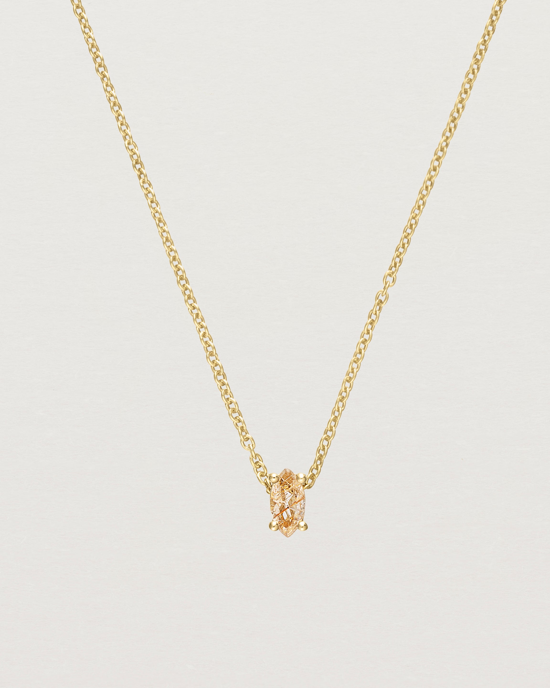 Close up of the Tiny Marquise Necklace with Rutilated Quartz in yellow gold.