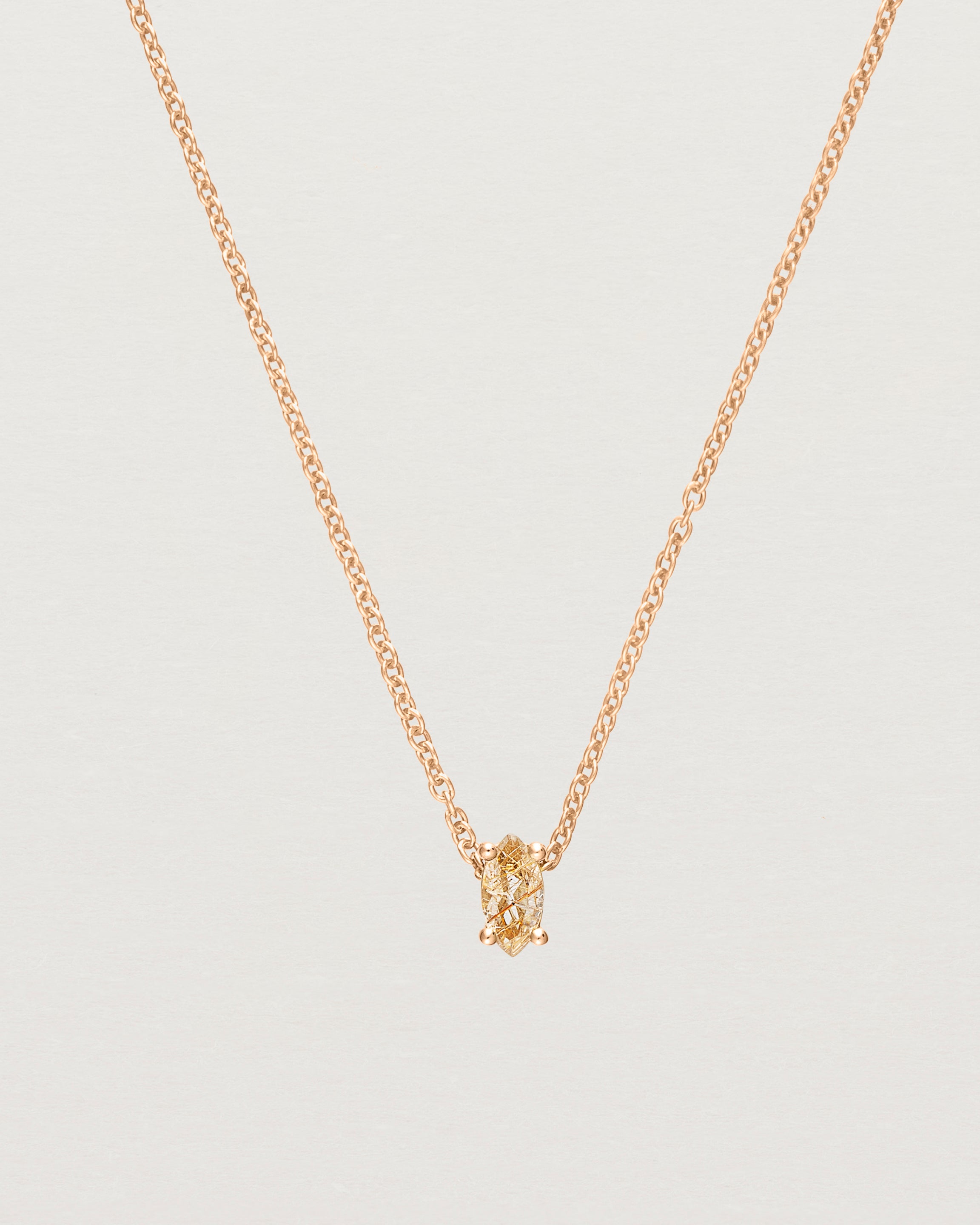 Close up of the Tiny Marquise Necklace with Rutilated Quartz in rose gold.