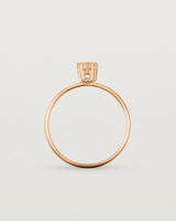 A fine rose gold ring featuring a pear shaped pink morganite stone