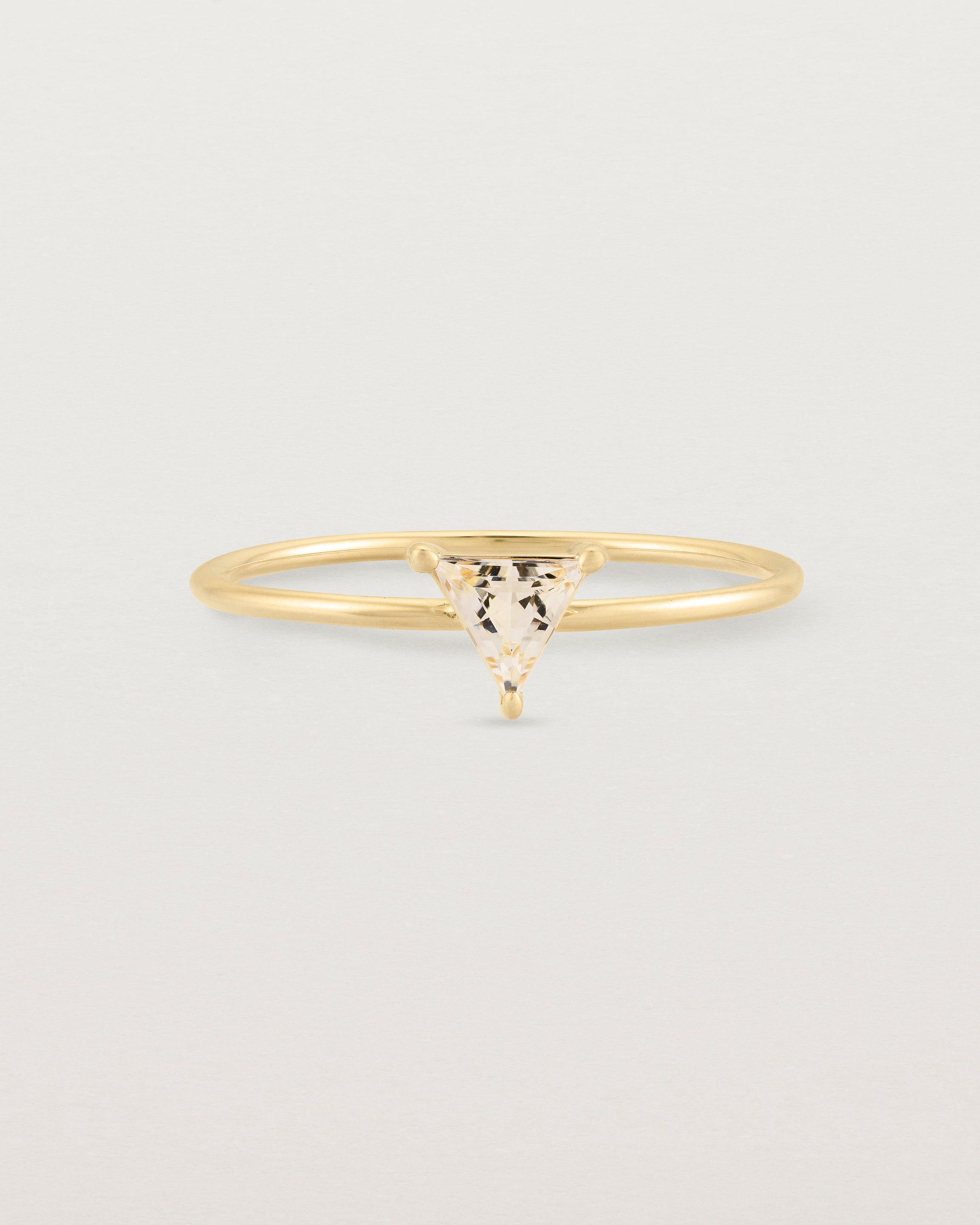 Fine yellow gold ring with a triangle shaped champagne shaped stone