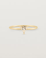 Fine yellow gold ring with a triangle shaped champagne shaped stone