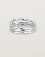 layered silver ring featuring a yellow gold ball suspended between two bands