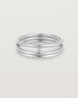 layered silver ring featuring a yellow gold ball suspended between two bands