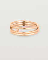 layered rose gold ring featuring a yellow gold ball suspended between two bands