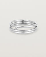 layered silver ring featuring a yellow gold ball suspended between two bands