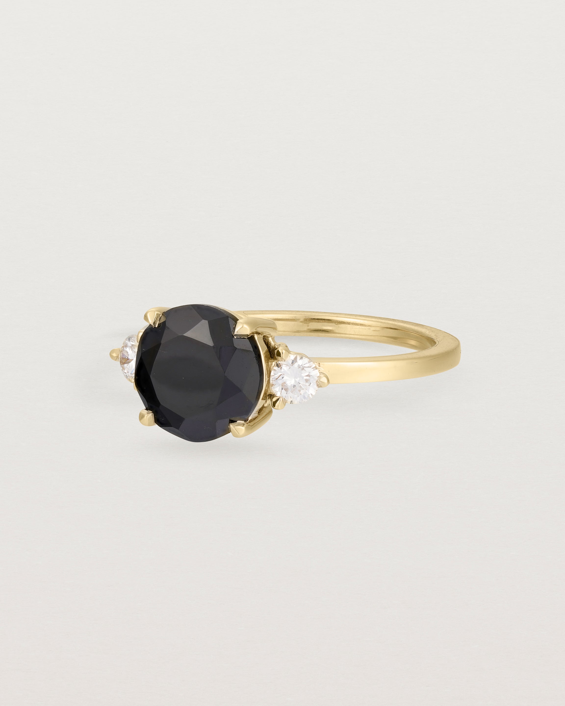 Angled view of the Una Round Trio Ring | Black Spinel & Diamonds | Yellow Gold.