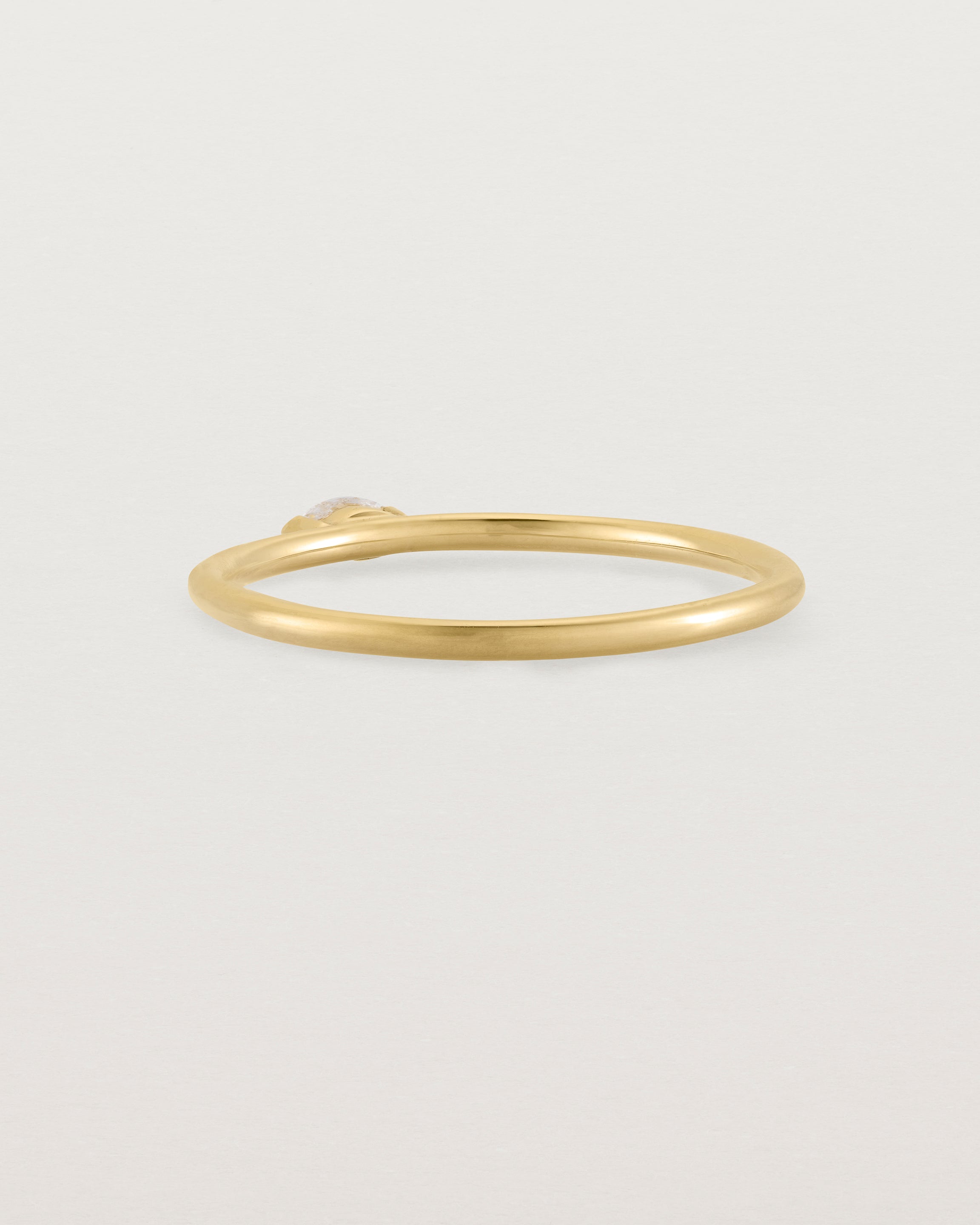 Fine yellow gold stacking ring featuring a white marquise centre diamond