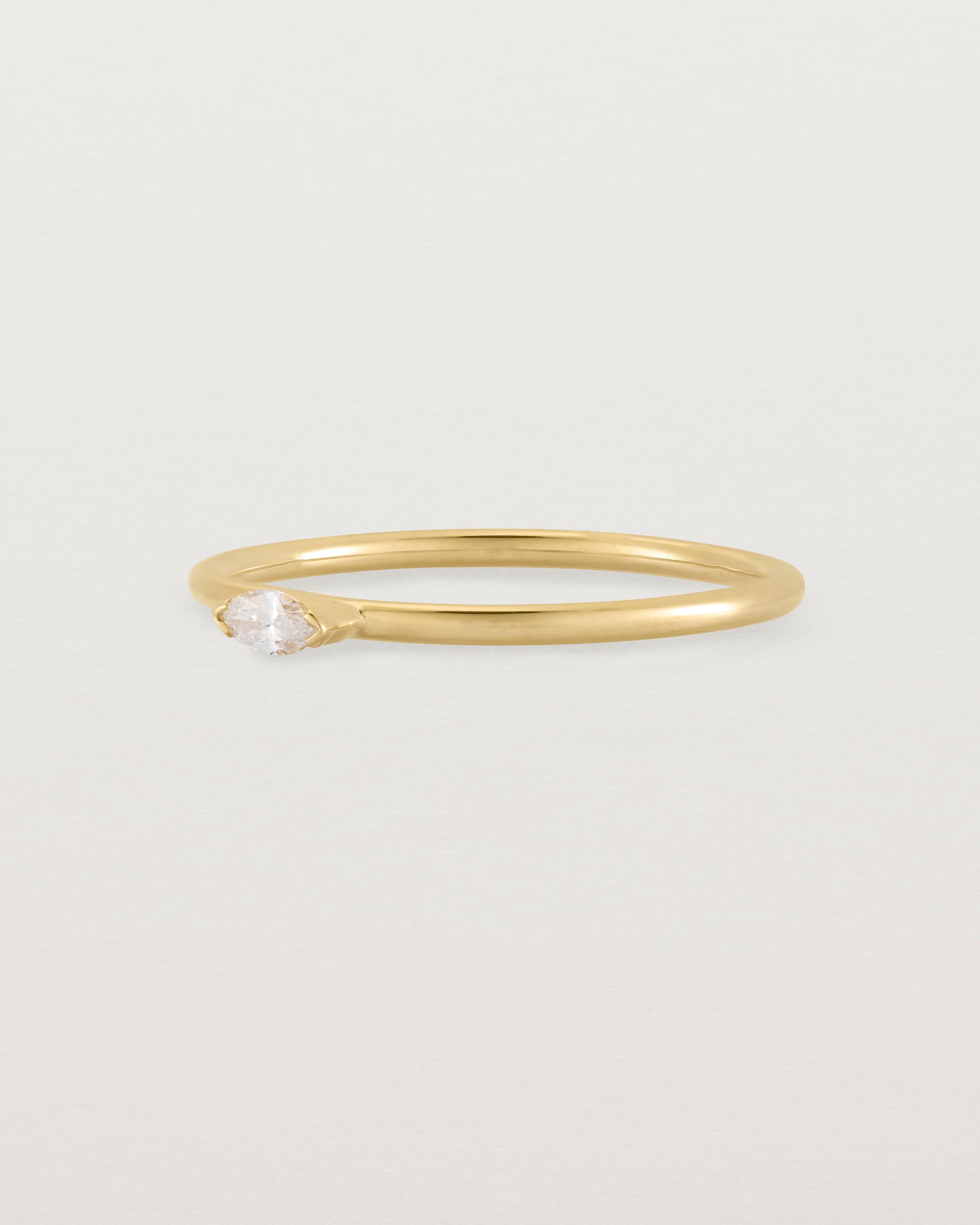 Fine yellow gold stacking ring featuring a white marquise centre diamond