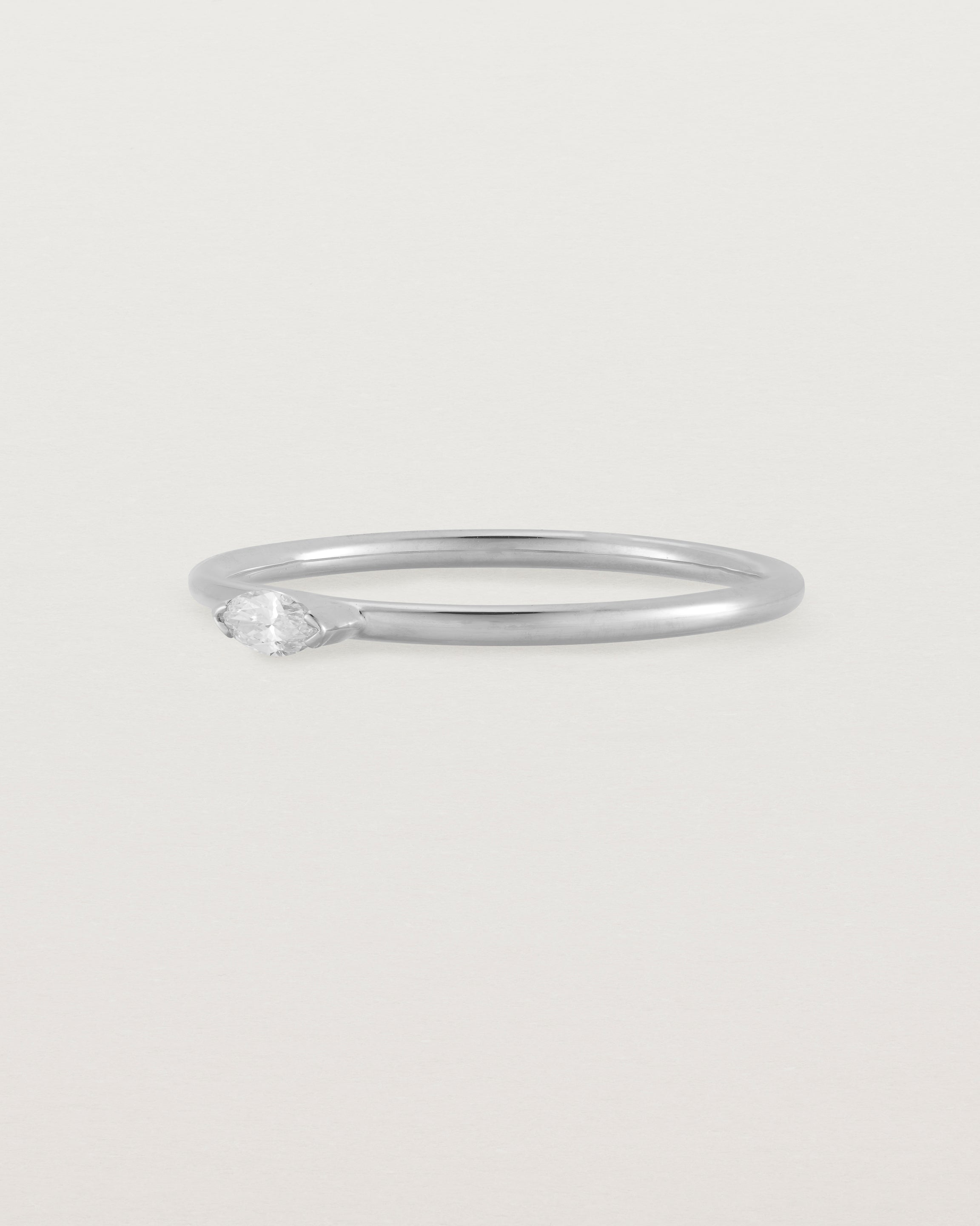 Fine white gold stacking ring featuring a white marquise centre diamond